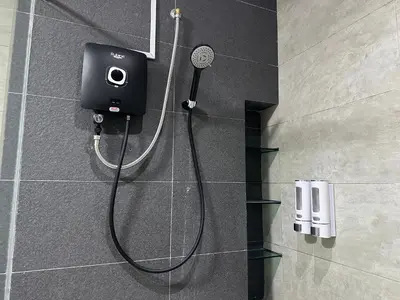 a shower in a bathroom with a camera on the wall at Fabulous Airport 2BR Suite# Straits Intl# Msg Chair in Bayan Lepas