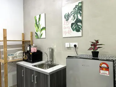 a kitchen with a sink and a microwave at Fabulous Airport 2BR Suite# Straits Intl# Msg Chair in Bayan Lepas