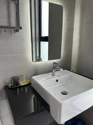 a bathroom with a white sink and a mirror at PICO VR, 3BR 3 queen bed, 2 car park, UrbanSuites by XW Home in Jelutong