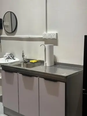 a kitchen counter with a sink and a mirror at Be Right Back Loft - Alma in Kampong Ayer Merah
