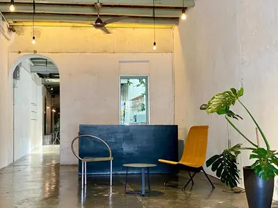 two chairs and a table in a room at The Frame Guesthouse in George Town