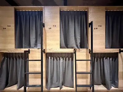 two bunk beds in a room with curtains at The Frame Guesthouse in George Town