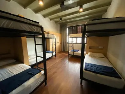 a room with three bunk beds in it at The Frame Guesthouse in George Town