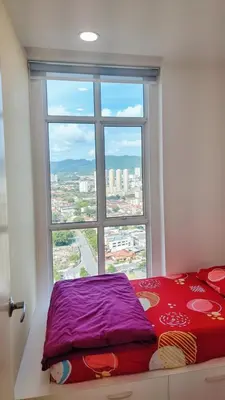 a bed in a room with a large window at 23th 2BR1B Straits Garden Suites Georgetown Jelutong in Jelutong