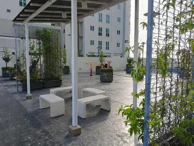 a group of benches in a courtyard with a building at 23th 2BR1B Straits Garden Suites Georgetown Jelutong in Jelutong