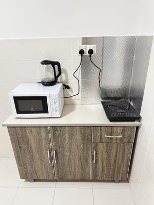 a counter with a microwave and a blender on it at TuR15 SPlCE 10pax 4room Private House in Bayan Lepas