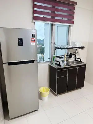 a kitchen with a refrigerator and a sink and a window at TuR15 SPlCE 10pax 4room Private House in Bayan Lepas