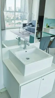 a bathroom with a white sink and a mirror at 29th 2BR1B Straits Garden Suites Georgetown Penang in George Town