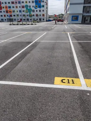 an empty parking lot with a sign on it at Modern Comfort Seri Iskandar in Seri Iskandar