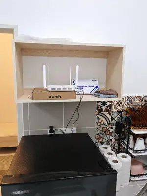 a shelf with a box on top of a printer at Modern Comfort Seri Iskandar in Seri Iskandar