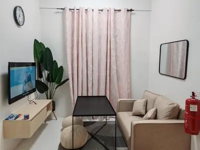a living room with a couch and a tv at Modern Comfort Seri Iskandar in Seri Iskandar