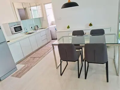 a kitchen with a glass table and four chairs at 28th 2BR1B Straits Garden Suites Georgetown Penang in Jelutong