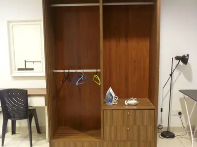 a room with a wooden wall with a desk and a chair at Studio at Middle floor sea view in George Town