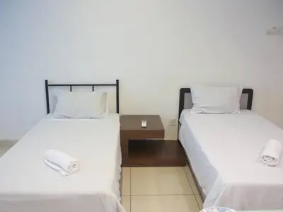 two beds sitting next to each other in a room at Studio at Middle floor sea view in George Town