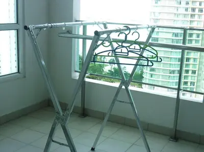 a ladder standing in front of a window at Studio at Middle floor sea view in George Town