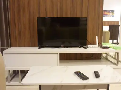 a flat screen tv sitting on top of a white table at Studio at Middle floor sea view in George Town