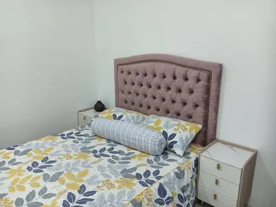 a bed with a pillow on top of it at The Bangau Cottage in Sungai Petani