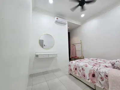 a bedroom with a bed and a mirror on the wall at The Bangau Cottage in Sungai Petani