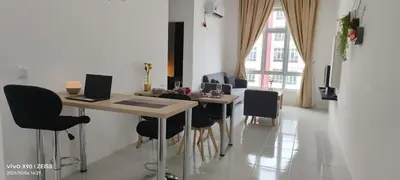 a dining room with a table and chairs with a laptop at Ipoh Anderson Free WiFi & Tvbox 4ppl in Ipoh