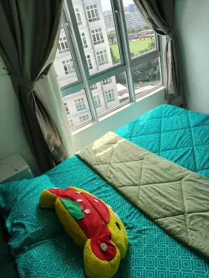 a pillow on a bed in front of a window at Ipoh Anderson Free WiFi & Tvbox 4ppl in Ipoh