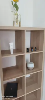 a wooden book shelf with a bowl and a vase at Ipoh Anderson Free WiFi & Tvbox 4ppl in Ipoh