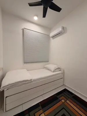 a bed in a room with a ceiling fan at NeoSkyhigh Suites in Batu Kawan