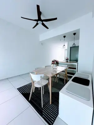 a dining room with a table and a ceiling fan at NeoSkyhigh Suites in Batu Kawan