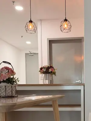 a mirror and two pendant lights over a counter at NeoSkyhigh Suites in Batu Kawan