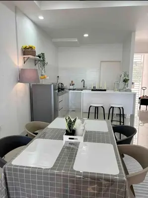 a kitchen with a table and chairs in a room at daisy apartment homestay taiping in Taiping