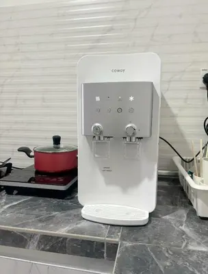 a white appliance sitting on a counter in a kitchen at daisy apartment homestay taiping in Taiping