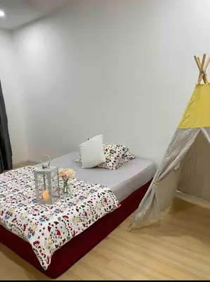 a bed in a room with a tent at daisy apartment homestay taiping in Taiping
