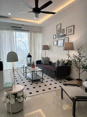 a living room with a couch and a table at daisy apartment homestay taiping in Taiping