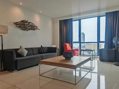a living room with a couch and a table at Luxe Romance with Seaview & Bathtub - Jazz Suites by Ocean Luxe in Tanjong Tokong