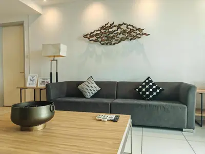 a living room with a couch and a coffee table at Luxe Romance with Seaview & Bathtub - Jazz Suites by Ocean Luxe in Tanjong Tokong