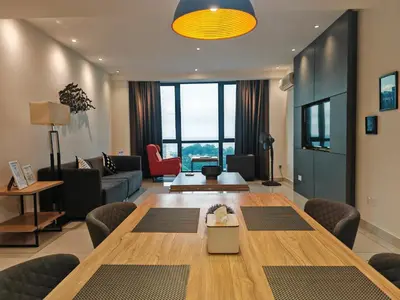 a living room with a large wooden table and chairs at Luxe Romance with Seaview & Bathtub - Jazz Suites by Ocean Luxe in Tanjong Tokong