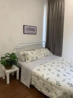 a bedroom with a bed and a potted plant at Ereens homestay 3 bedroom apartment in Brinchang