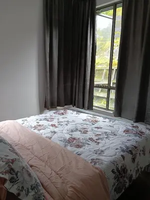a bed in a room with a window at Raissa Resident palas horizon Cameron Highlands in Brinchang