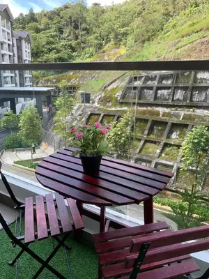a wooden table with a potted plant on a balcony at Raissa Resident palas horizon Cameron Highlands in Brinchang