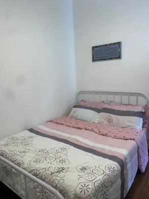 a bed in a room with a white wall at Raissa Resident palas horizon Cameron Highlands in Brinchang