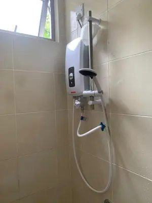a shower in a bathroom with a hand dryer on a wall at Raissa Resident palas horizon Cameron Highlands in Brinchang