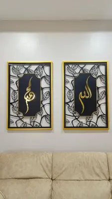 two framed pictures on a wall above a couch at Zulfa Homestay Teluk Intan in Teluk Intan