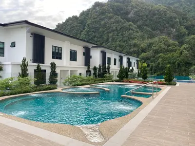 a swimming pool in front of a building at Sunway Onsen Ipoh Tambun Cozy Retreat 8pax in Tambun