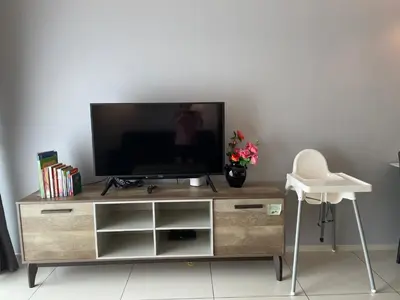 a flat screen tv sitting on top of a wooden entertainment center at Sunway Onsen Ipoh Tambun Cozy Retreat 8pax in Tambun