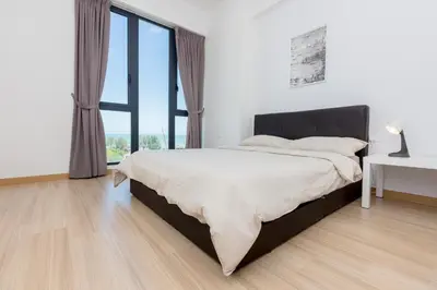 a bedroom with a large bed and a large window at Jazz Luxury Suites BY MEXI in Tanjong Tokong
