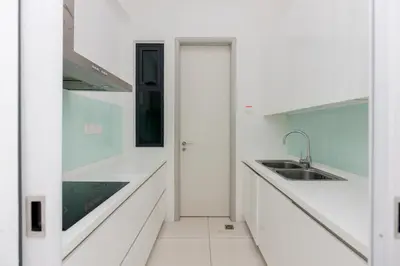 a kitchen with white counters and a sink at Jazz Luxury Suites BY MEXI in Tanjong Tokong