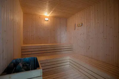 a wooden sauna with a bench in the middle at Jazz Luxury Suites BY MEXI in Tanjong Tokong