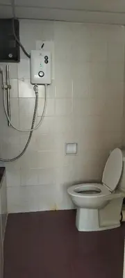 a bathroom with a toilet and a shower at Bayu Emas Apartment in Batu Ferringhi