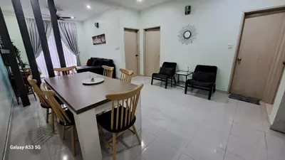 a dining room and living room with a table and chairs at Husinza Two LWOT in Ipoh