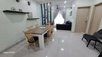 a dining room and living room with a table and chairs at Husinza Two LWOT in Ipoh