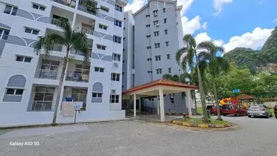 a large white building with palm trees in a parking lot at Husinza Two LWOT in Ipoh